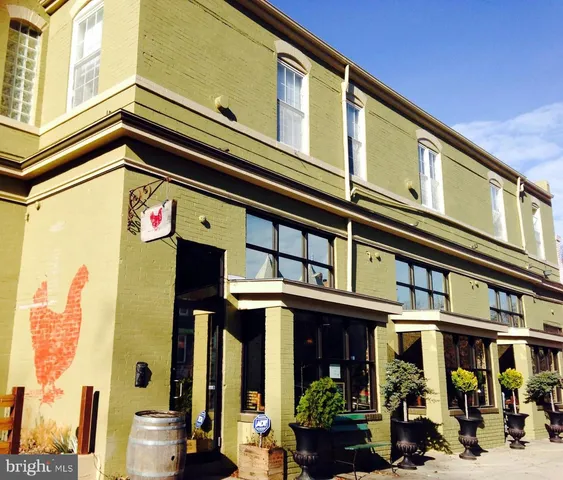 a living room with furniture and a window and a book shelf