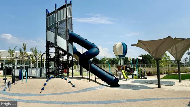 a view of a water fountain in front of a yard