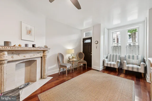 a open kitchen with sink stove and white cabinets with wooden floor