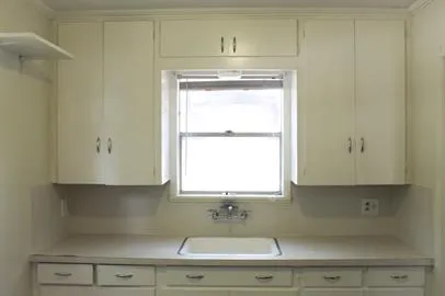 a sink with window and cabinet