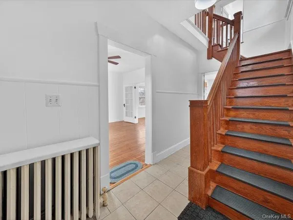 a view of entryway with stairs and wooden floor