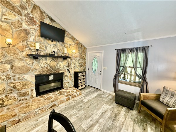 238 Trails End Road Blue Ridge, GA 30513 - Photo 7 of 32 a bedroom with furniture a flat screen tv and a fireplace