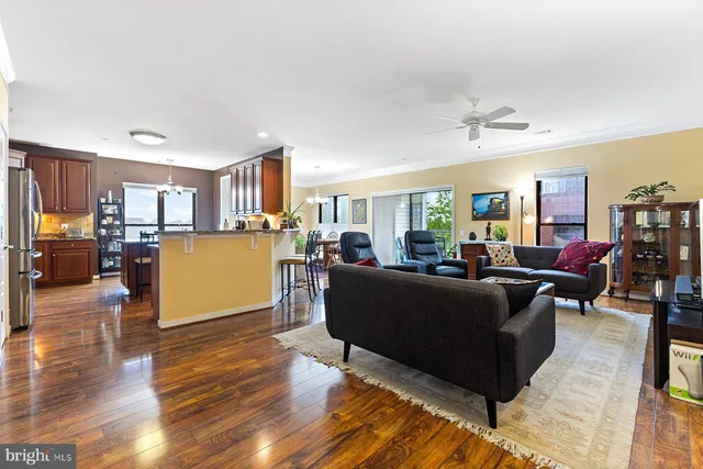 a living room with furniture and a wooden floor