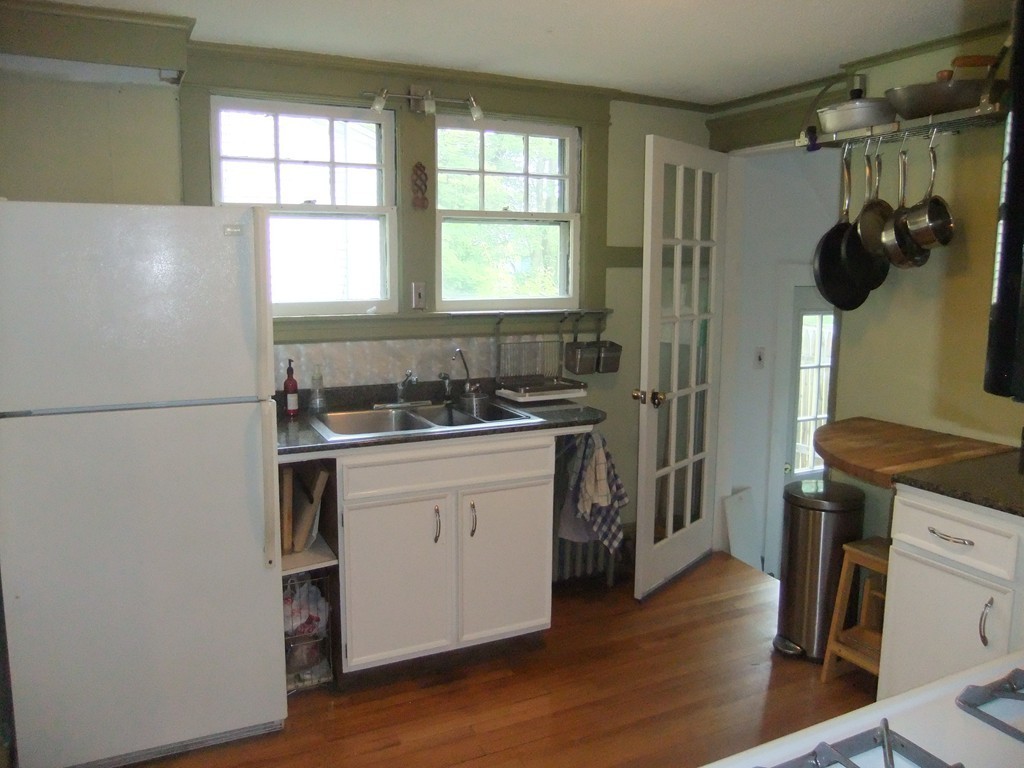 53 Newhall Street Springfield, MA 01109 - Photo 12 of 29 a kitchen with a refrigerator and a stove top oven