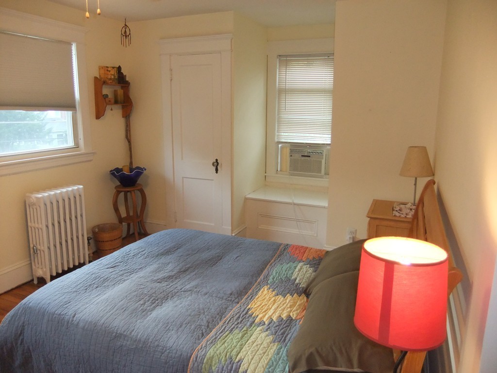 53 Newhall Street Springfield, MA 01109 - Photo 19 of 29 a bedroom with a bed and a chandelier
