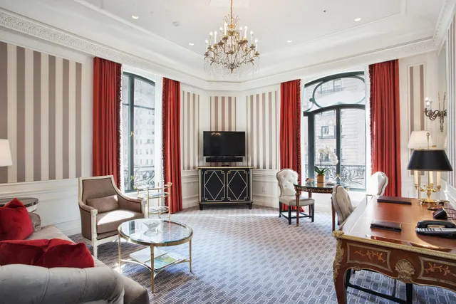 a living room with furniture a flat screen tv and a large window