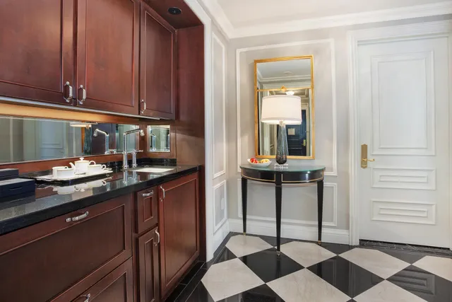 a bathroom with a tub sink and mirror