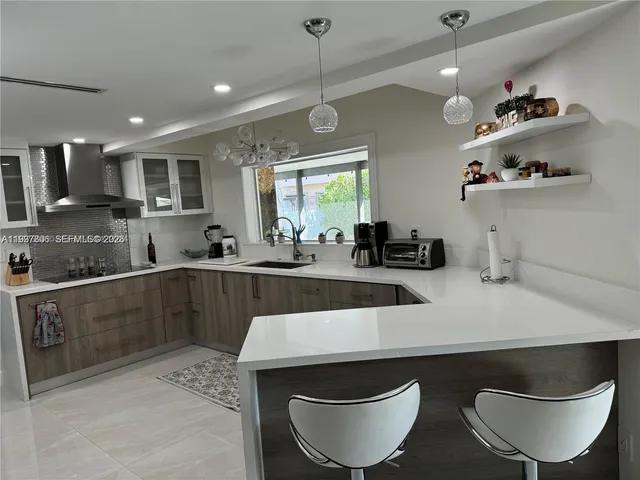 a kitchen with a table chairs stove and cabinets