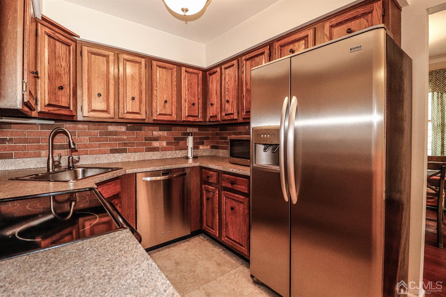 32 Rector Avenue Woodbridge, NJ 07095 - Photo 9 of 29 a kitchen with stainless steel appliances granite countertop a refrigerator and a sink