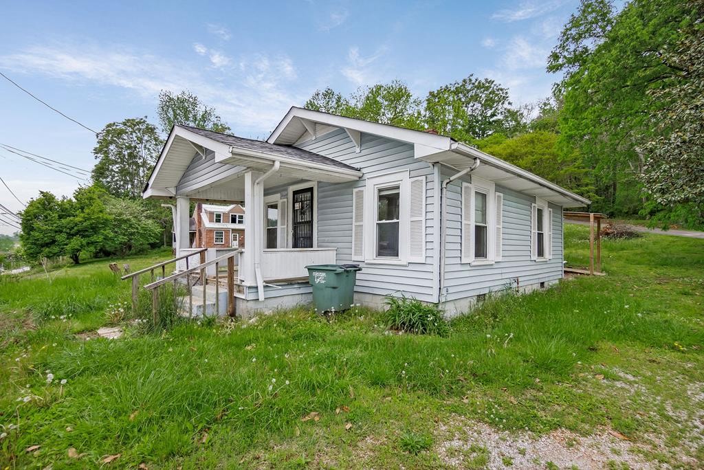147 Mayberry Street Sparta, TN 38583 - Photo 1 of 22 a front view of a house with a garden and trees