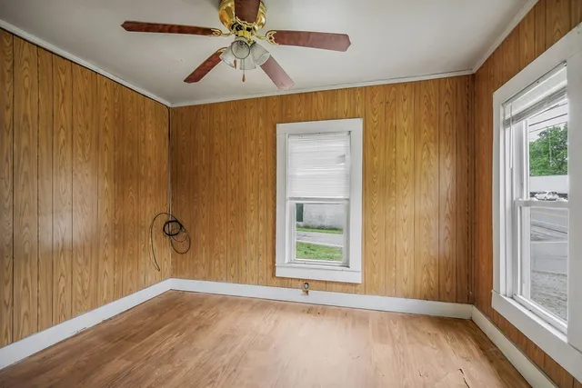 wooden floor in an empty room with a window