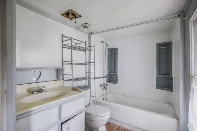 a bathroom with a sink toilet tub and shower
