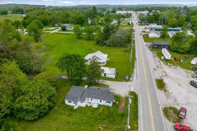 an aerial view of a house with a yard basket ball court and outdoor seating