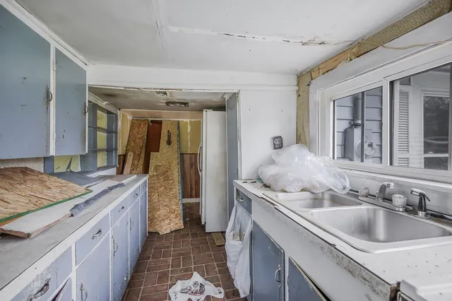 a bathroom with a granite countertop sink and a large mirror