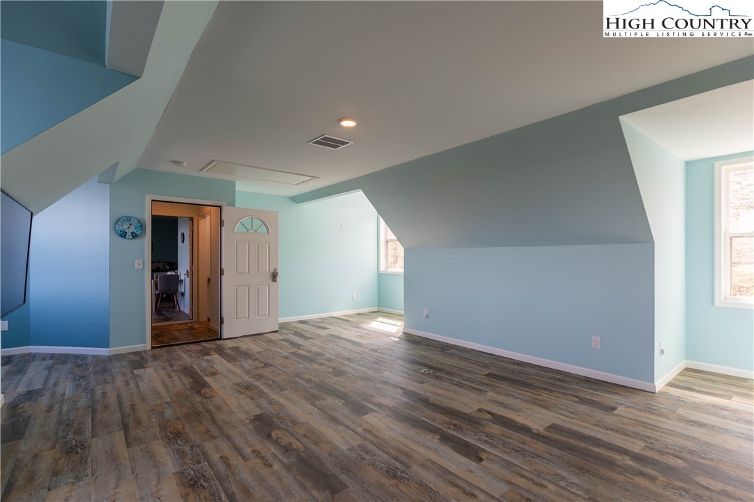 449 Meadow Ridge Drive Jefferson, NC 28640 - Photo 20 of 37 a view of an empty room and window and wooden floor