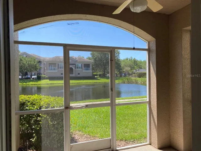 a blue swimming pool is in the backyard of a house