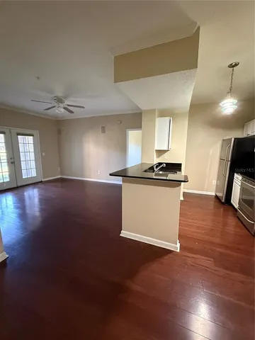 a kitchen with a refrigerator and a stove top oven