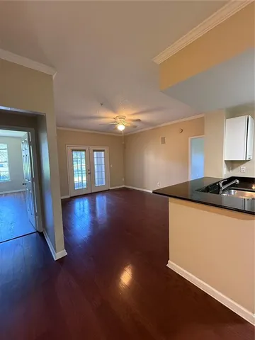 a view of a kitchen with wooden floor and a sink