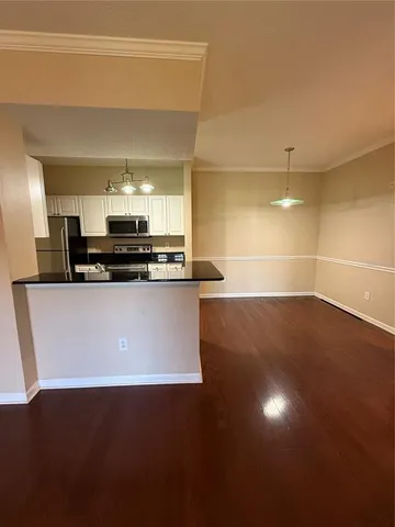 a view of kitchen with stainless steel appliances a sink
