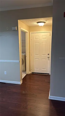 an empty room with wooden floor and closet