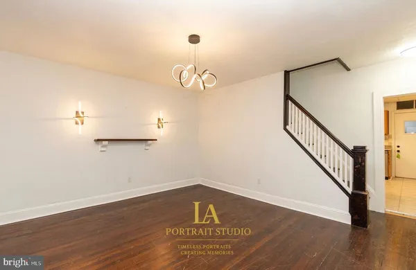 a view of a room with wooden floor