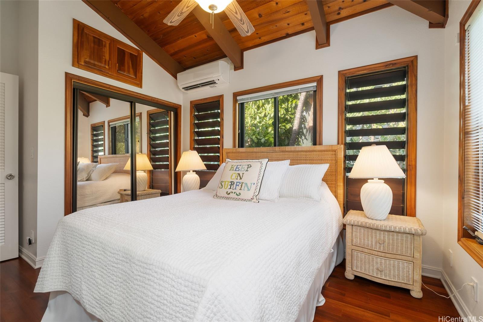 59-377 Ke Nui Road Haleiwa, HI 96712 - Photo 11 of 25 a bedroom with bed and wooden floor