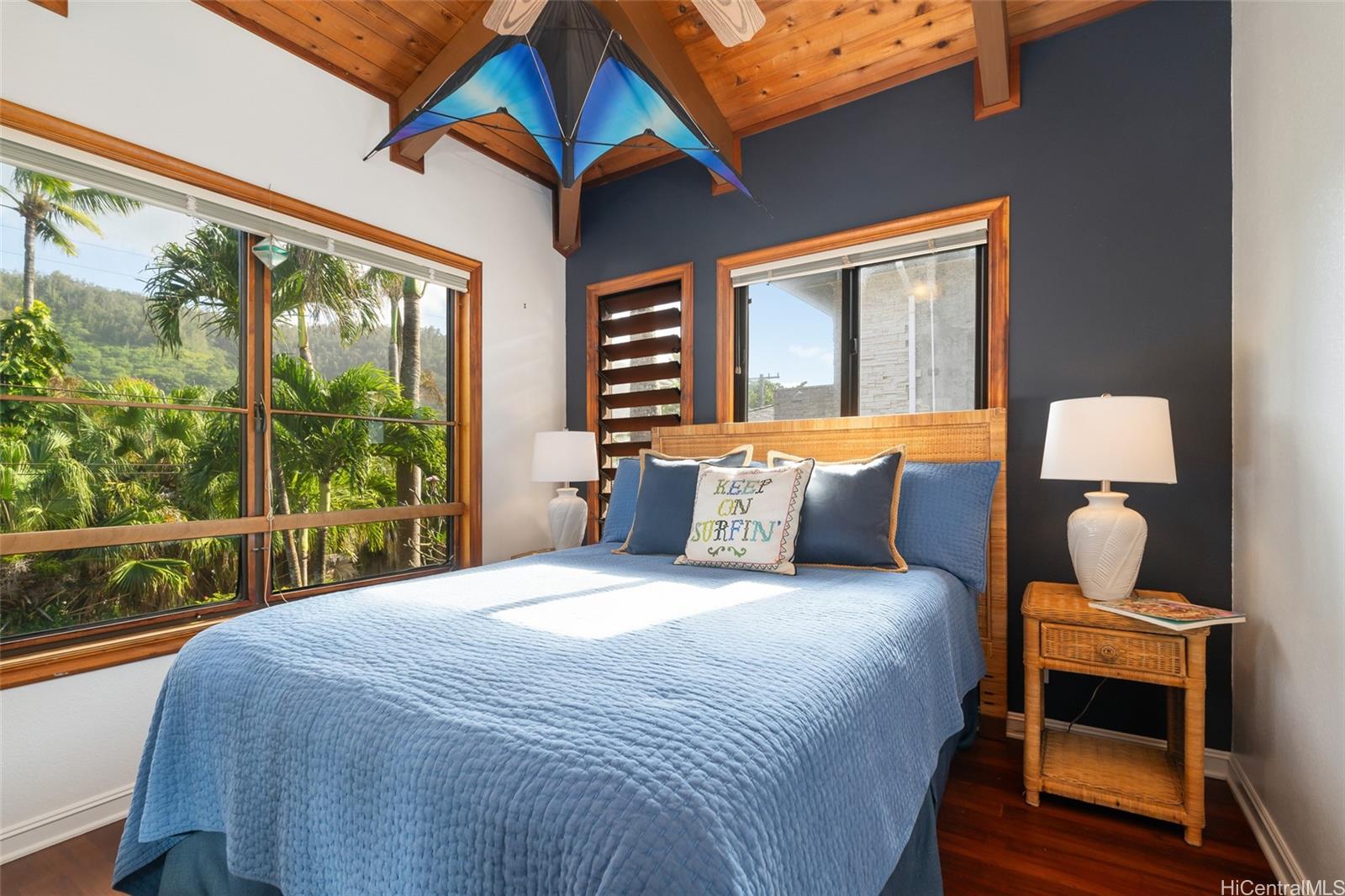 59-377 Ke Nui Road Haleiwa, HI 96712 - Photo 13 of 25 a bedroom with a bed and wooden floor