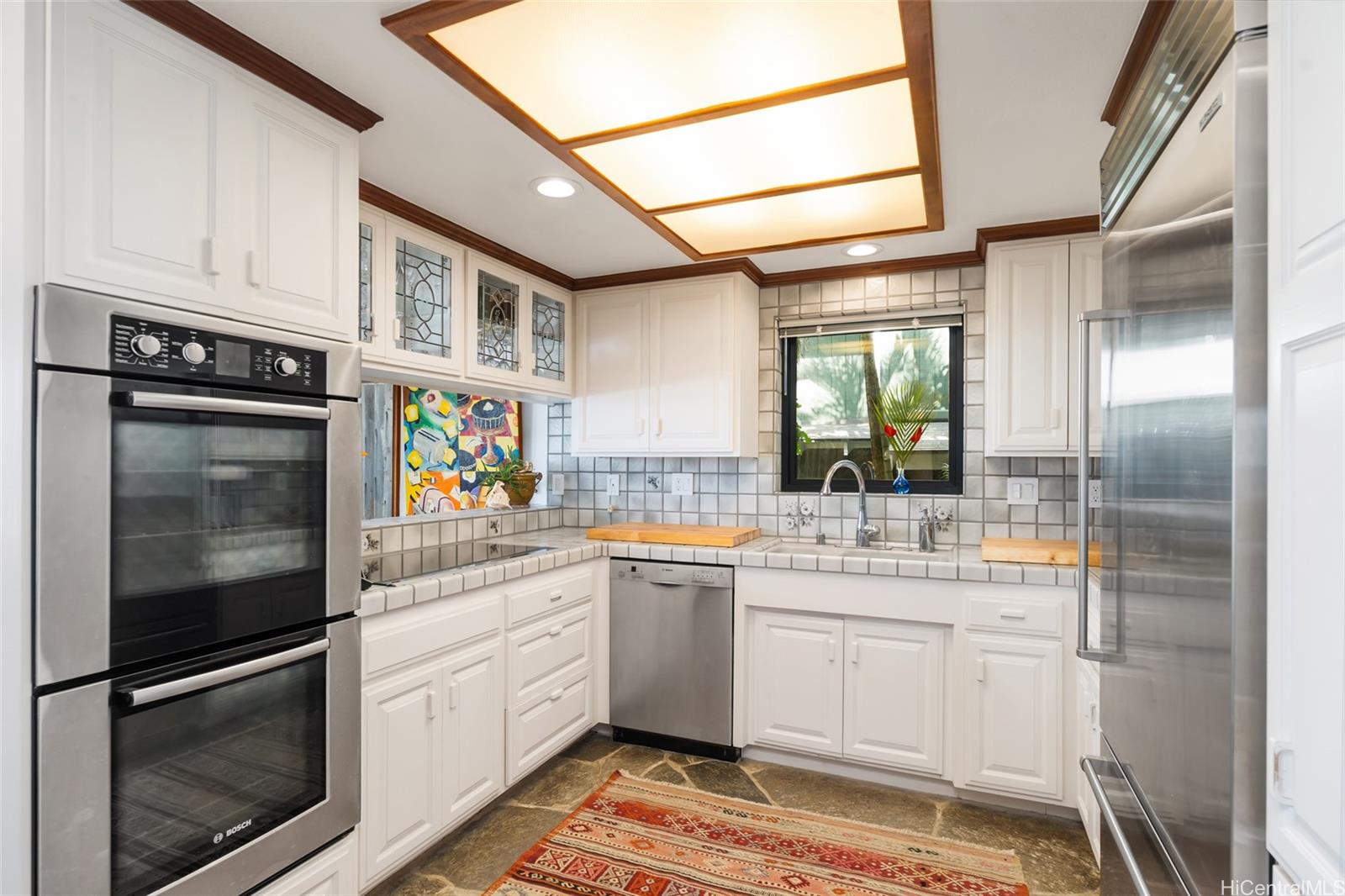 59-377 Ke Nui Road Haleiwa, HI 96712 - Photo 10 of 25 a kitchen with stainless steel appliances granite countertop a refrigerator and a stove