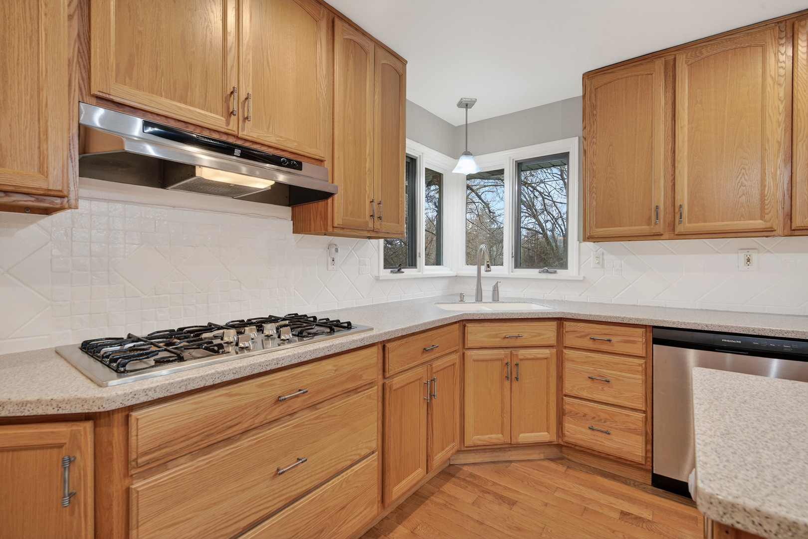 38-w042 Silver Glen Road St. Charles, IL 60175 - Photo 11 of 40 a kitchen with white cabinets and appliances
