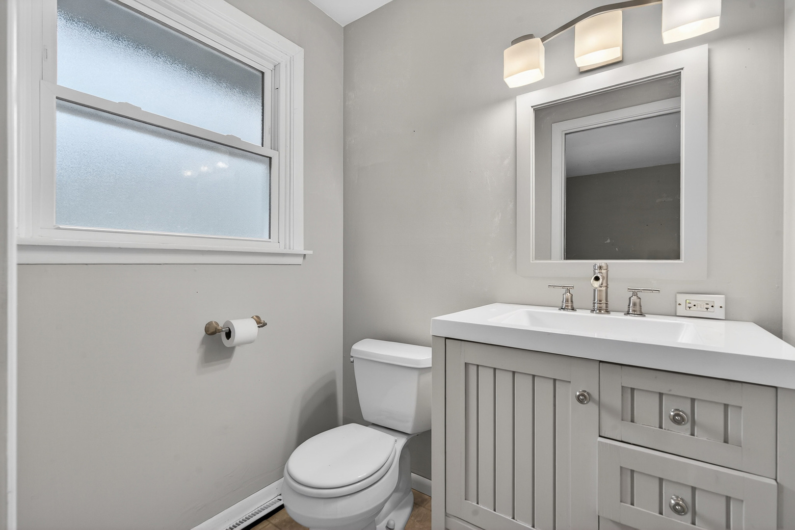 38-w042 Silver Glen Road St. Charles, IL 60175 - Photo 17 of 40 a bathroom with a toilet a sink a vanity and mirror