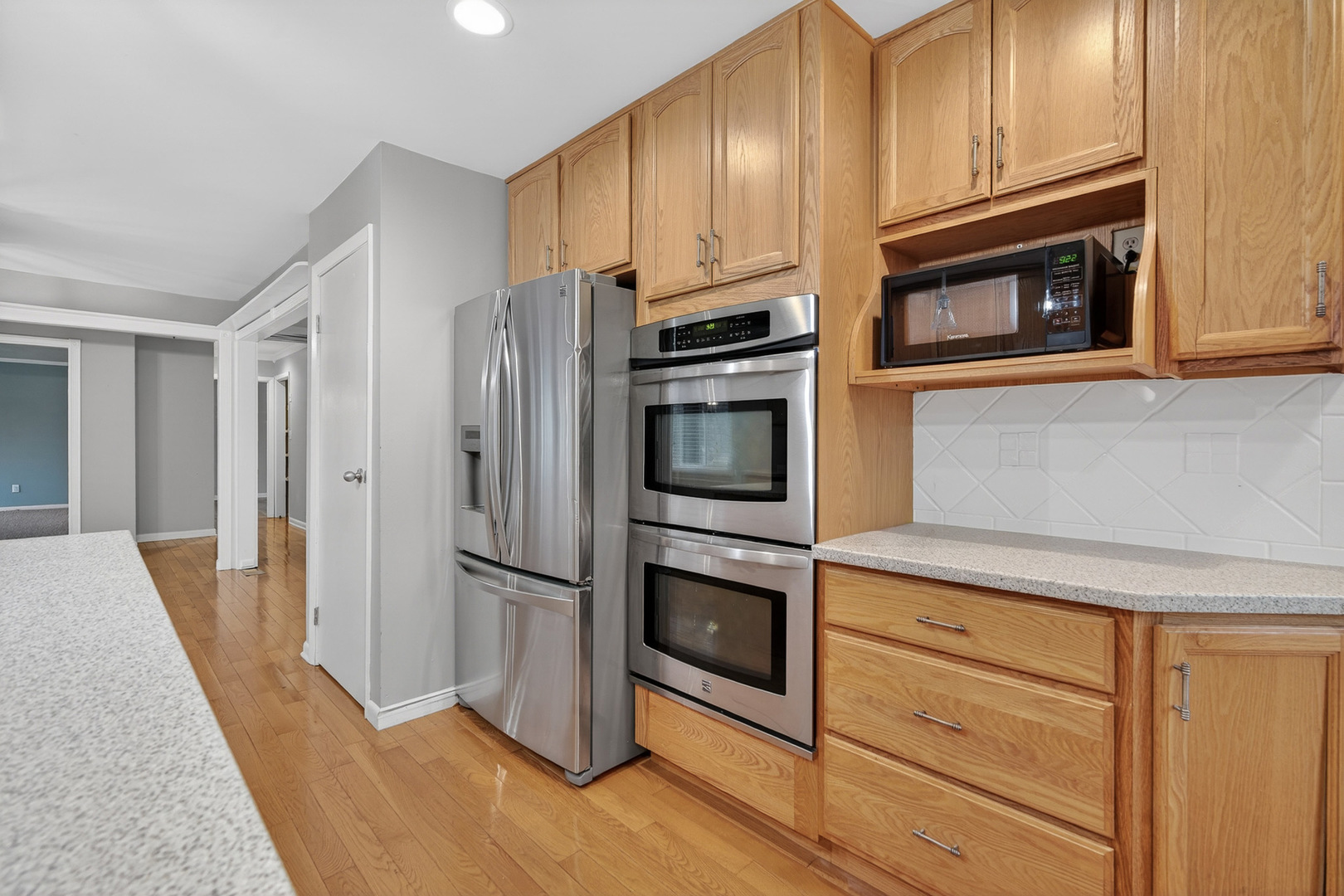 38-w042 Silver Glen Road St. Charles, IL 60175 - Photo 10 of 40 a kitchen with stainless steel appliances granite countertop a refrigerator microwave and stove