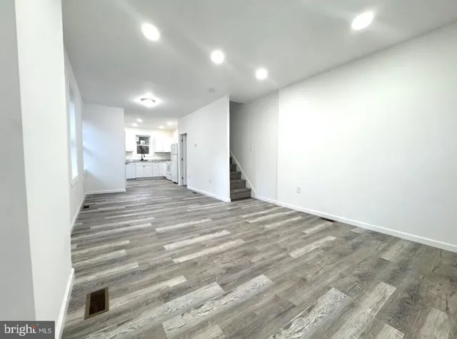 a view of entryway and hall with wooden floor