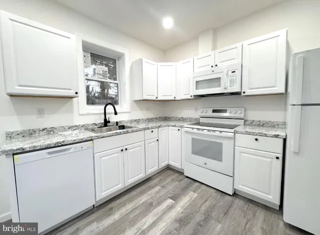 an empty room with wooden floor and entryway