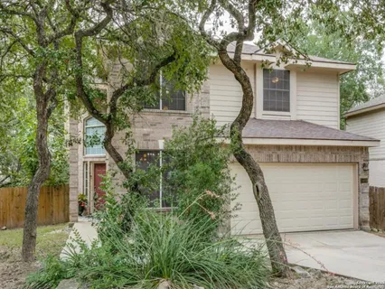 front view of a house with a tree