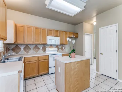 a kitchen with a sink stove and cabinets