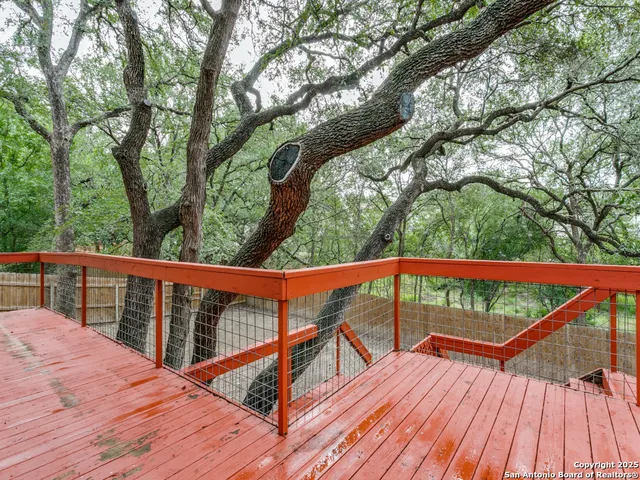 a view of mountain with deck and trees