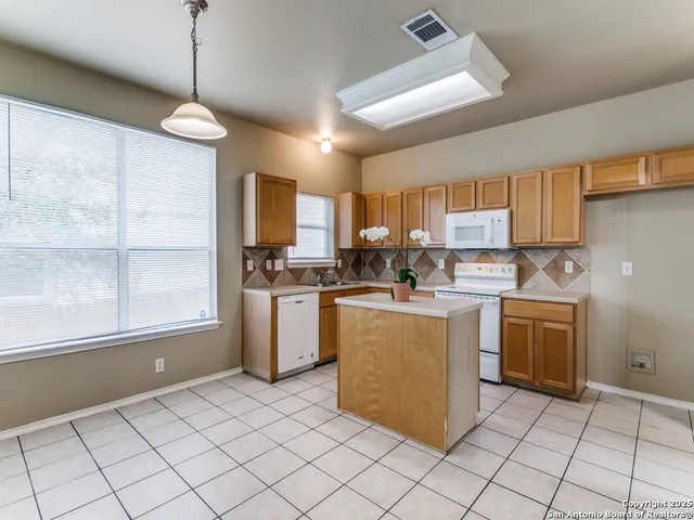 a kitchen with cabinets and window