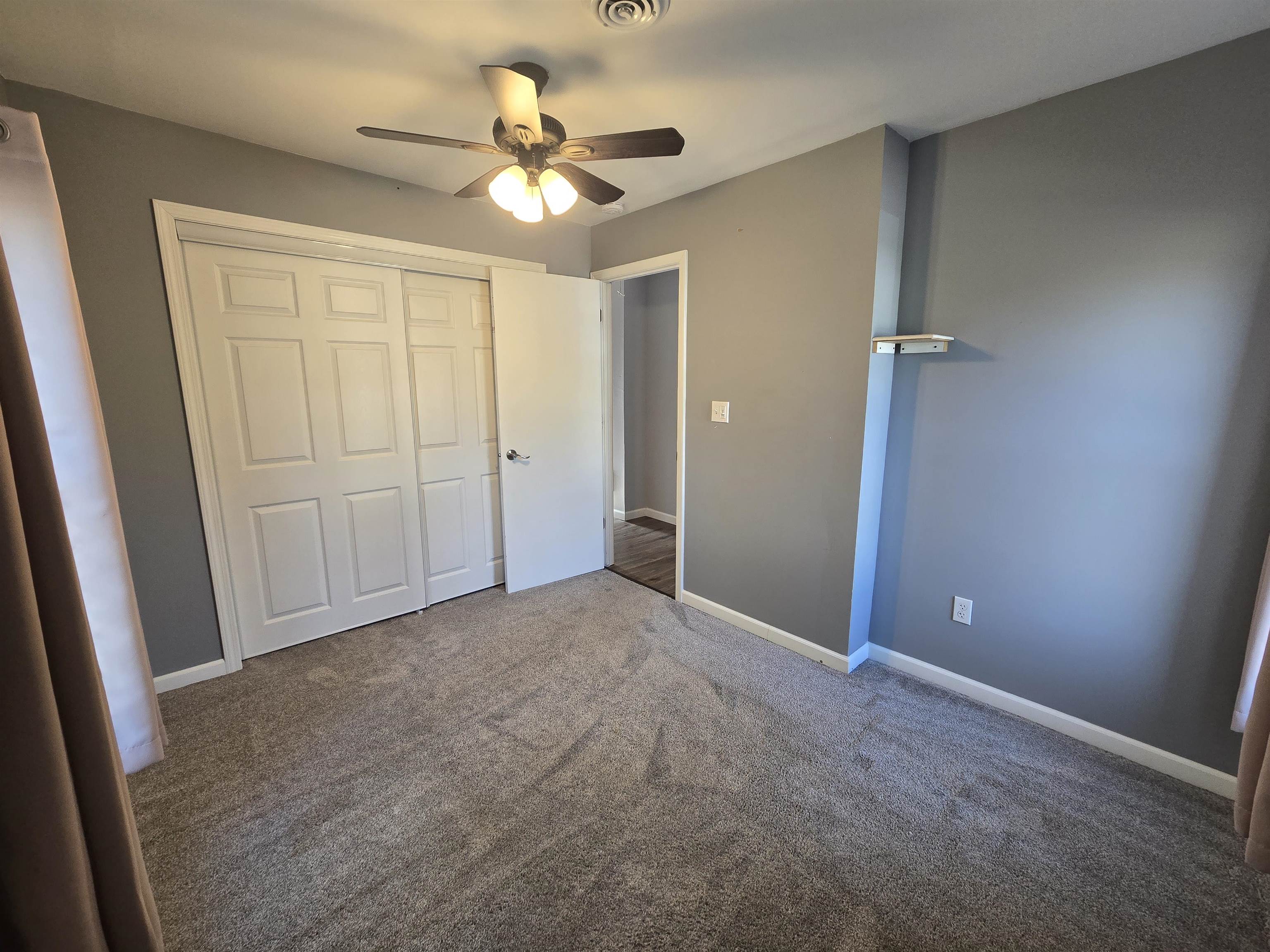 732 West 2nd Street Byron, IL 61010 - Photo 15 of 22 an empty room with closet and a ceiling fan