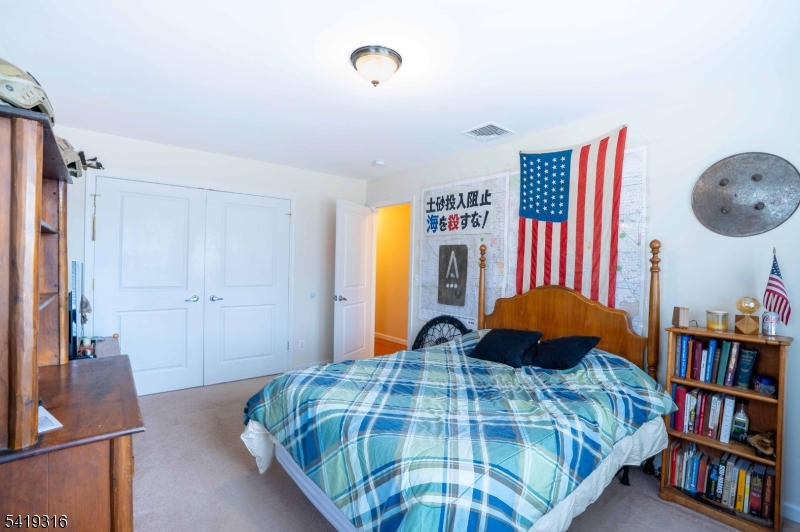 2 Lilac Road Lake Hopatcong, NJ 07849 - Photo 13 of 34 a bedroom with a bed and a book shelf