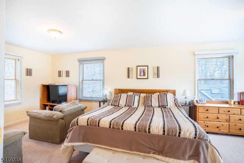 2 Lilac Road Lake Hopatcong, NJ 07849 - Photo 14 of 34 a bedroom with a bed and wooden floor