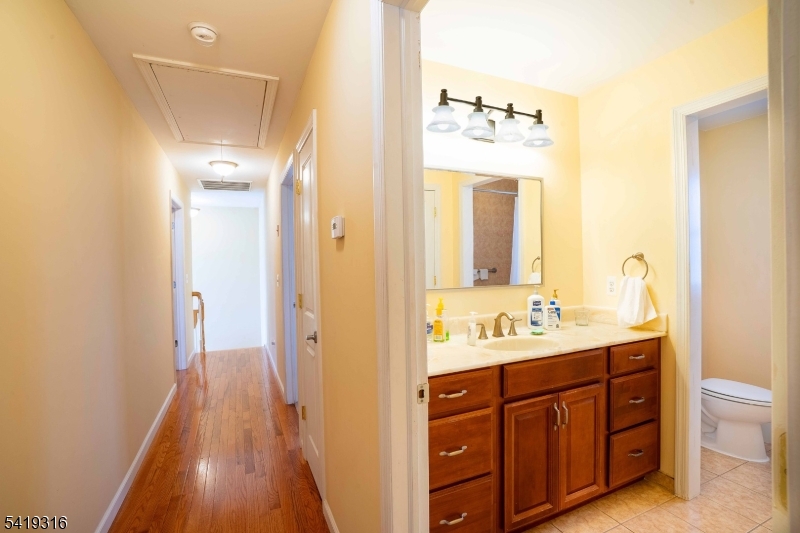 2 Lilac Road Lake Hopatcong, NJ 07849 - Photo 17 of 34 a bathroom with a double vanity sink mirror and toilet