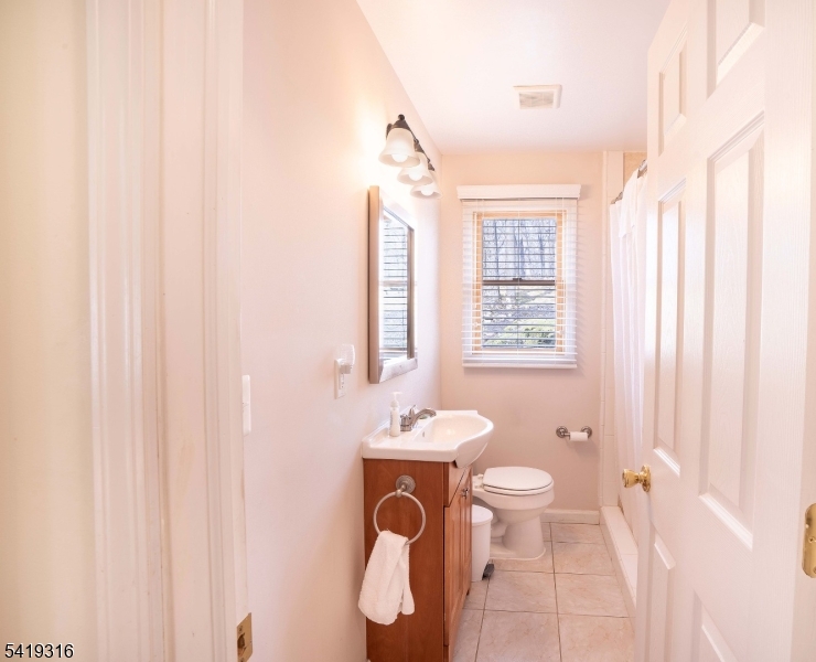 2 Lilac Road Lake Hopatcong, NJ 07849 - Photo 18 of 34 a bathroom with a toilet sink and mirror