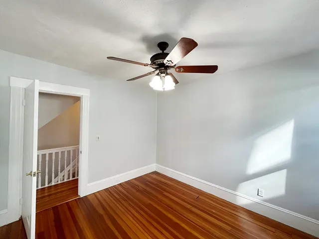 a view of a room with wooden floor and window