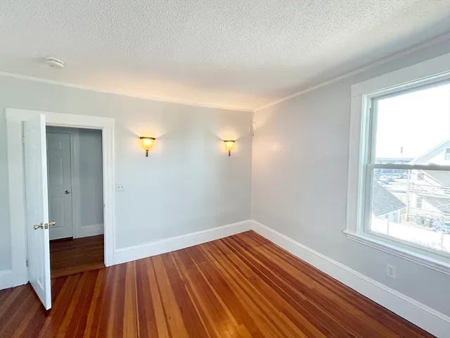 wooden floor in an empty room with a window and wooden floor