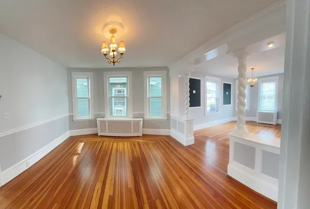 a large white kitchen with cabinets