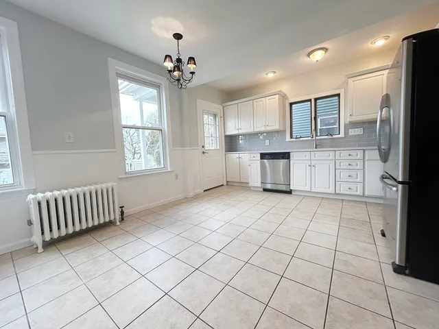 a kitchen with stainless steel appliances granite countertop a refrigerator and a sink
