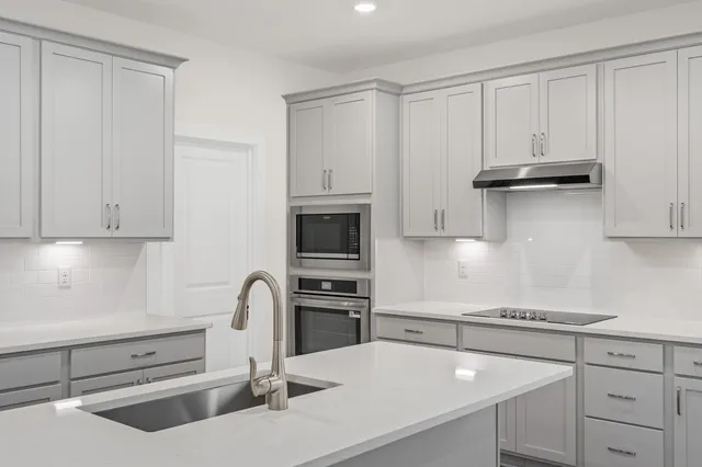 a kitchen with granite countertop cabinets and steel stainless steel appliances