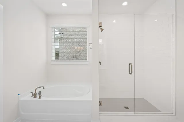 a living room with furniture a flat screen tv and a table