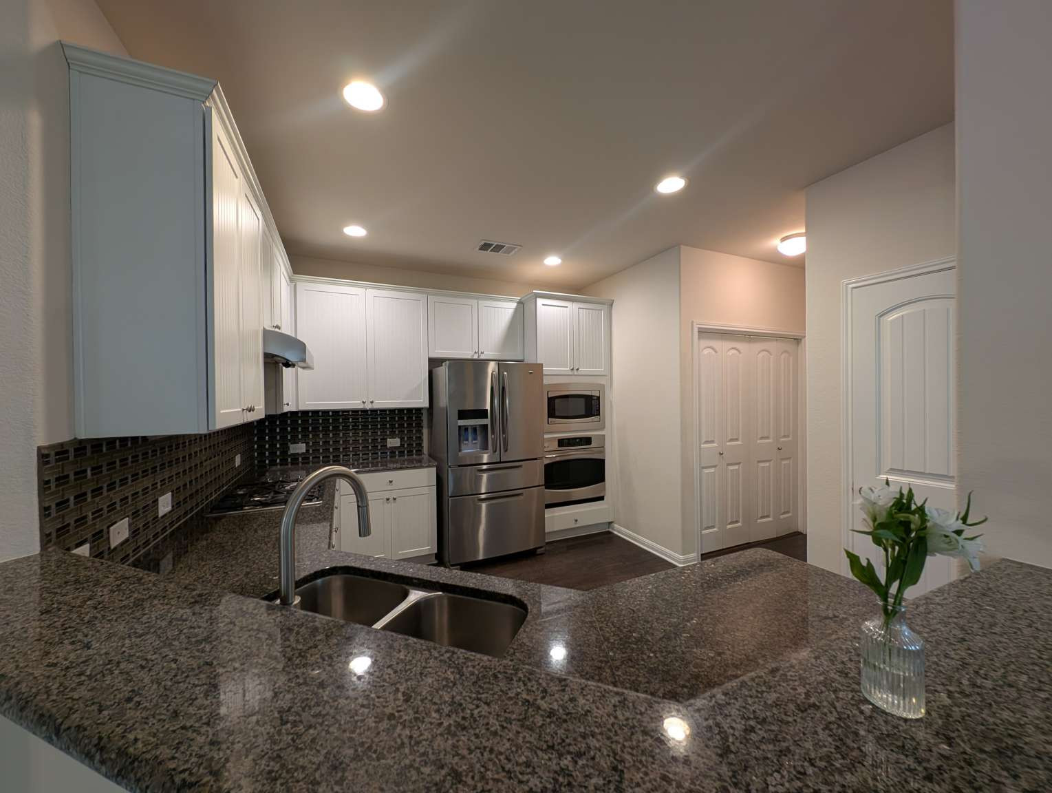 7301 Bandera Ranch Trail, Unit A Austin, TX 78750 - Photo 5 of 20 Culinary delights await in this modern kitchen, featuring sleek countertops and contemporary appliances.