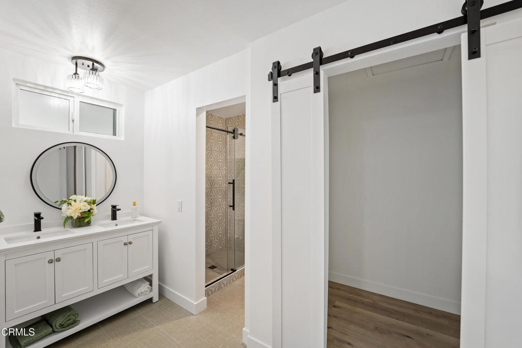 930 Topsail Court Oxnard, CA 93035 - Photo 11 of 31 a bathroom with a double vanity sink and a mirror